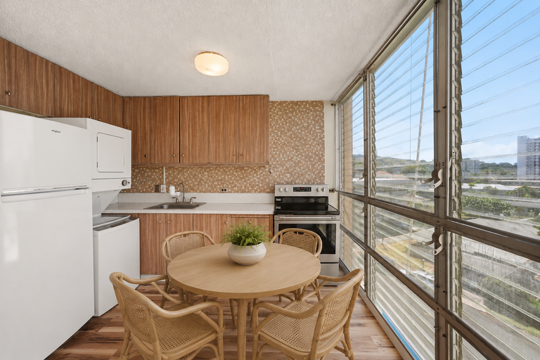 Kitchen and dining area with jalousie windows and mountain view