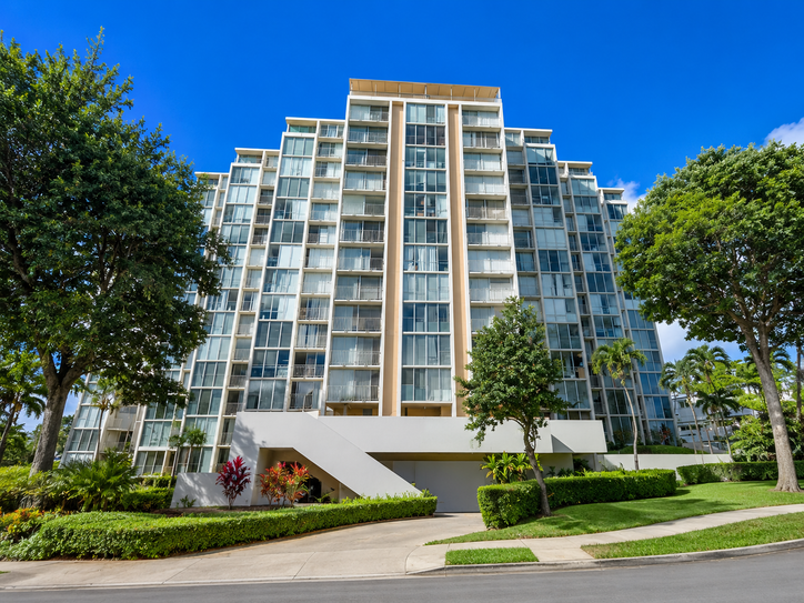 Front facade of the Hale O Kalani Towers building under a blue sky